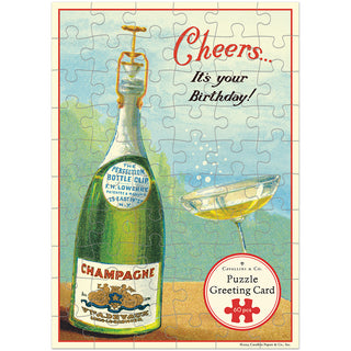 The Cavallini & Co. "Happy Birthday Champagne" 60-piece greeting card puzzle features a champagne bottle and full glass with the text “Cheers… It’s your Birthday!”.