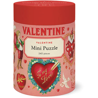 A cylindrical box with a red lid holds Cavallini & Co.’s Valentine 240 Piece Jigsaw Puzzle, featuring vintage Valentine images, hearts, doves, and “To my Love” text. Includes a biodegradable bag. Finished size: 10.5" x 14".