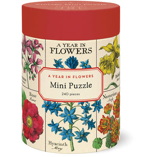 The A Year in Flowers 240 Piece Jigsaw Puzzle by Cavallini & Co. comes in a cylindrical container with floral illustrations and a red lid, includes pieces in a biodegradable bag, and forms a 10.5" x 14" puzzle when complete.